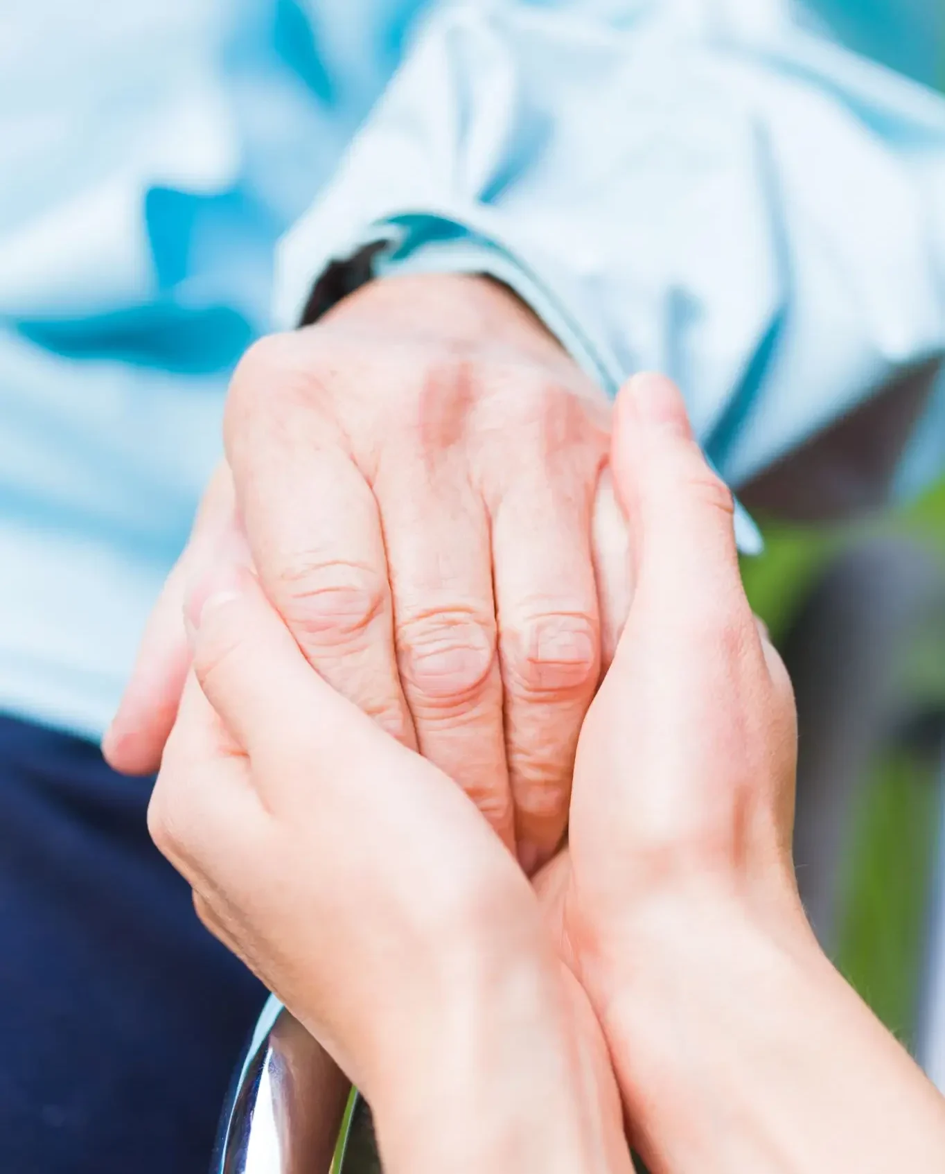 Hands holding each other gently.